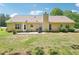 Expansive backyard with a patio area, lush lawn, and mature trees, perfect for outdoor enjoyment at 20 Queensland Ln, Covington, GA 30016