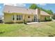 Spacious backyard with lush green grass, a patio, and mature landscaping, perfect for outdoor gatherings at 20 Queensland Ln, Covington, GA 30016