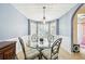 Cozy dining room features a decorative ceiling, bay windows, and stylish furnishings at 20 Queensland Ln, Covington, GA 30016