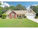 Charming home with a well-maintained lawn and colorful flowerbeds and a two car garage at 20 Queensland Ln, Covington, GA 30016