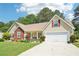 Charming home with a well-maintained lawn and colorful flowerbeds and a two car garage at 20 Queensland Ln, Covington, GA 30016