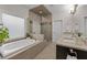 Spacious bathroom featuring a large soaking tub, glass shower and double vanity at 2601 Boulder Way, Woodstock, GA 30188