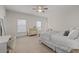 Bedroom with a ceiling fan, neutral colored walls and two bright windows at 2601 Boulder Way, Woodstock, GA 30188