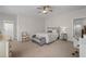 Bedroom with a ceiling fan, upholstered chair and attached bathroom at 2601 Boulder Way, Woodstock, GA 30188