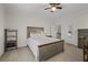 This spacious bedroom features neutral tones, lots of natural light, and a ceiling fan at 2601 Boulder Way, Woodstock, GA 30188