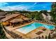 Spacious community pool with plenty of lounge chairs, a shaded clubhouse, and manicured landscaping at 2601 Boulder Way, Woodstock, GA 30188