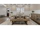 Elegant dining room features a wooden table with bench seating, stylish chandelier, and large window at 2601 Boulder Way, Woodstock, GA 30188