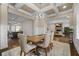 Open-concept dining room showcasing coffered ceilings, a rustic table, and seamless flow to living spaces at 2601 Boulder Way, Woodstock, GA 30188