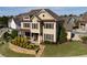 Beautiful two-story home with manicured lawn and stone retaining wall at 2601 Boulder Way, Woodstock, GA 30188