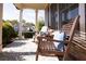 Inviting front porch with rocking chairs, a patterned rug, and elegant columns at 2601 Boulder Way, Woodstock, GA 30188