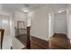 Upstairs hallway featuring hardwood floors, a decorative mirror, and access to bedrooms at 2601 Boulder Way, Woodstock, GA 30188