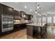 Modern kitchen boasting dark cabinetry, stainless steel appliances, a large island and hardwood floors at 2601 Boulder Way, Woodstock, GA 30188