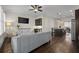 Comfortable living room with a plush gray sofa, media console and kitchen view at 2601 Boulder Way, Woodstock, GA 30188