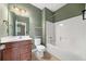 Bathroom featuring wooden cabinets, a shower-tub combo, and a single sink at 548 Myrtle Trace Ln, Suwanee, GA 30024