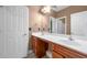Bathroom with double sinks, wood cabinets, and a large mirror at 548 Myrtle Trace Ln, Suwanee, GA 30024