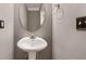 Bathroom featuring a pedestal sink with an oval mirror and modern fixtures at 548 Myrtle Trace Ln, Suwanee, GA 30024