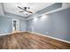 Spacious bedroom features wood flooring, recessed lighting, and a ceiling fan at 548 Myrtle Trace Ln, Suwanee, GA 30024