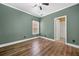 Bedroom with wood-look floors, and a window with blinds at 548 Myrtle Trace Ln, Suwanee, GA 30024