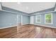 Bright bedroom with wood floors, recessed lights, and two windows offering natural light at 548 Myrtle Trace Ln, Suwanee, GA 30024