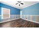 Bedroom features wood-look floors, a ceiling fan, and a single window at 548 Myrtle Trace Ln, Suwanee, GA 30024