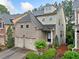 Beautifully landscaped home featuring a brick front and inviting entrance at 548 Myrtle Trace Ln, Suwanee, GA 30024