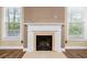 Elegant fireplace with white mantel and windows on either side at 548 Myrtle Trace Ln, Suwanee, GA 30024