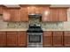 Updated kitchen with stainless steel gas range, granite counters, and custom cabinets at 548 Myrtle Trace Ln, Suwanee, GA 30024