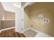 A spacious laundry room features tile flooring and a white door at 548 Myrtle Trace Ln, Suwanee, GA 30024