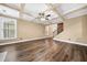 Spacious living area with wood floors, coffered ceiling, and lots of natural light at 548 Myrtle Trace Ln, Suwanee, GA 30024