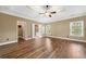 Spacious main bedroom with tray ceilings, a ceiling fan, and ample natural light from the windows at 548 Myrtle Trace Ln, Suwanee, GA 30024