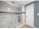 The shower features sleek glass doors, built-in shelving, and stylish tile at 548 Myrtle Trace Ln, Suwanee, GA 30024
