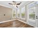 Bright sunroom with hardwood floors, ceiling fan, and exterior access at 548 Myrtle Trace Ln, Suwanee, GA 30024