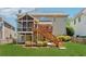 Exterior view of home with a screened-in porch overlooking the spacious backyard and lush landscaping at 1632 Chadwick Ridge Dr, Lawrenceville, GA 30043