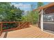 Spacious wooden deck with railings offering a great view of the surrounding greenery and tranquil setting at 1632 Chadwick Ridge Dr, Lawrenceville, GA 30043