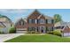Beautiful two-story brick home with lush green lawn, attached garage, and well-maintained landscaping at 1632 Chadwick Ridge Dr, Lawrenceville, GA 30043