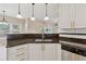 Granite countertops, stainless sink, and white cabinets in a bright, updated kitchen at 1632 Chadwick Ridge Dr, Lawrenceville, GA 30043