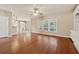 Inviting living room featuring hardwood floors, a ceiling fan, and natural light from multiple windows at 1632 Chadwick Ridge Dr, Lawrenceville, GA 30043