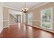Bright and airy living room with hardwood floors, crown molding, and staircase access at 1632 Chadwick Ridge Dr, Lawrenceville, GA 30043