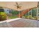 Covered patio area with tiled flooring, fan, and stairs leading to a lush, landscaped backyard, perfect for relaxation at 1632 Chadwick Ridge Dr, Lawrenceville, GA 30043