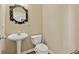 Elegant powder room featuring pedestal sink, decorative mirror, and updated fixtures at 1632 Chadwick Ridge Dr, Lawrenceville, GA 30043