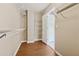 Spacious walk-in closet with wood flooring and ample shelving at 1632 Chadwick Ridge Dr, Lawrenceville, GA 30043