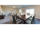 This dining area offers a wood table set and opens to the living room, creating an inviting space at 2389 Argento Cir, Dacula, GA 30019