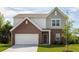 Charming two-story home with a brick facade, two-car garage, and well-manicured lawn at 2389 Argento Cir, Dacula, GA 30019