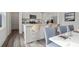 Modern kitchen with white cabinetry, stainless steel appliances, and a breakfast bar with seating at 2389 Argento Cir, Dacula, GA 30019