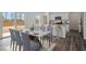 Open-concept dining area with a marble table and modern kitchen with stainless steel appliances at 2389 Argento Cir, Dacula, GA 30019