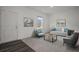 Bright living room with modern decor, comfortable seating, and natural light from a window at 2389 Argento Cir, Dacula, GA 30019