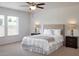 Serene bedroom featuring a queen-size bed, bedside tables, and windows providing natural light at 2389 Argento Cir, Dacula, GA 30019