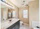 Bathroom features large mirror, vanity, tile floor, and shower with glass doors at 2426 Windridge Dr, Conyers, GA 30013