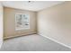 Cozy bedroom with gray carpeting, neutral walls, and a bright window at 2426 Windridge Dr, Conyers, GA 30013