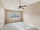 Bedroom with high ceilings, large window providing ample light, and carpeted flooring at 2426 Windridge Dr, Conyers, GA 30013